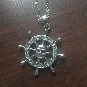 Skull face charm on an anchor